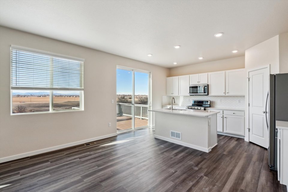 A kitchen with white cabinets.