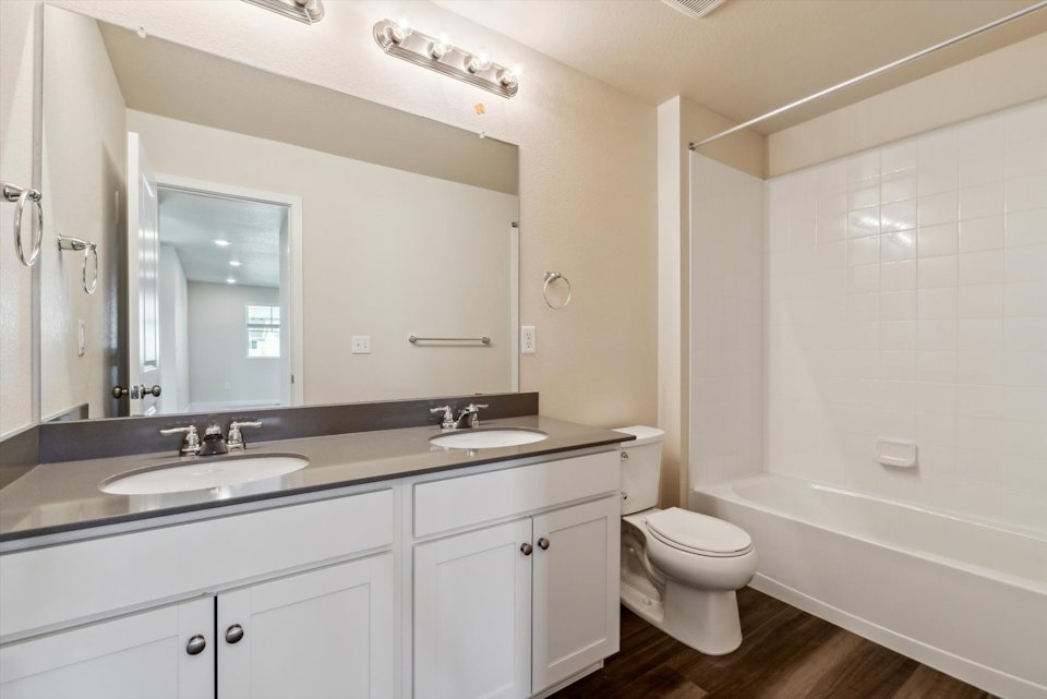 A bathroom with a tub sink and toilet.