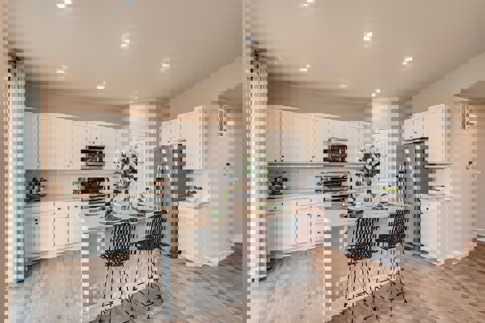 A kitchen with white cabinets.
