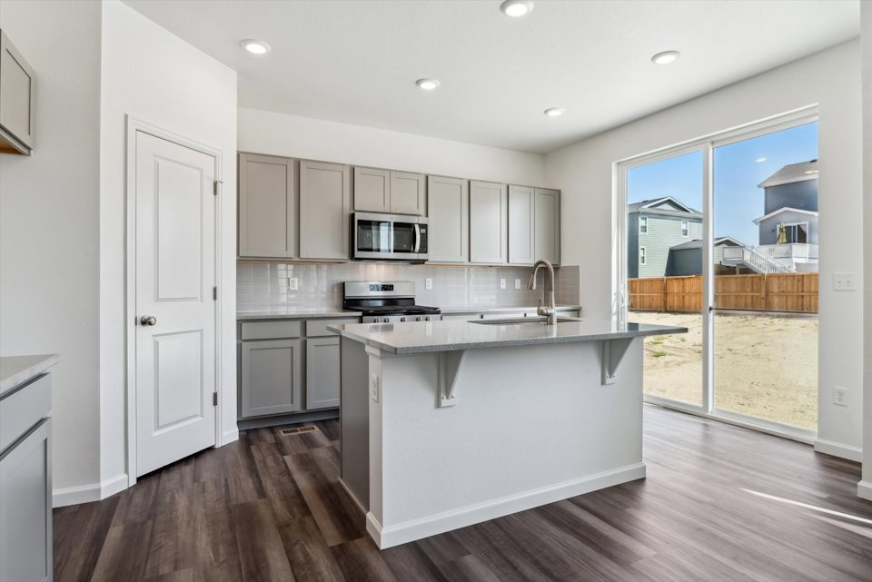A kitchen with white cabinets.