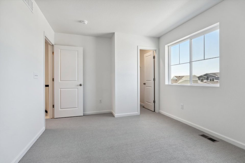 A room with white walls and a window.