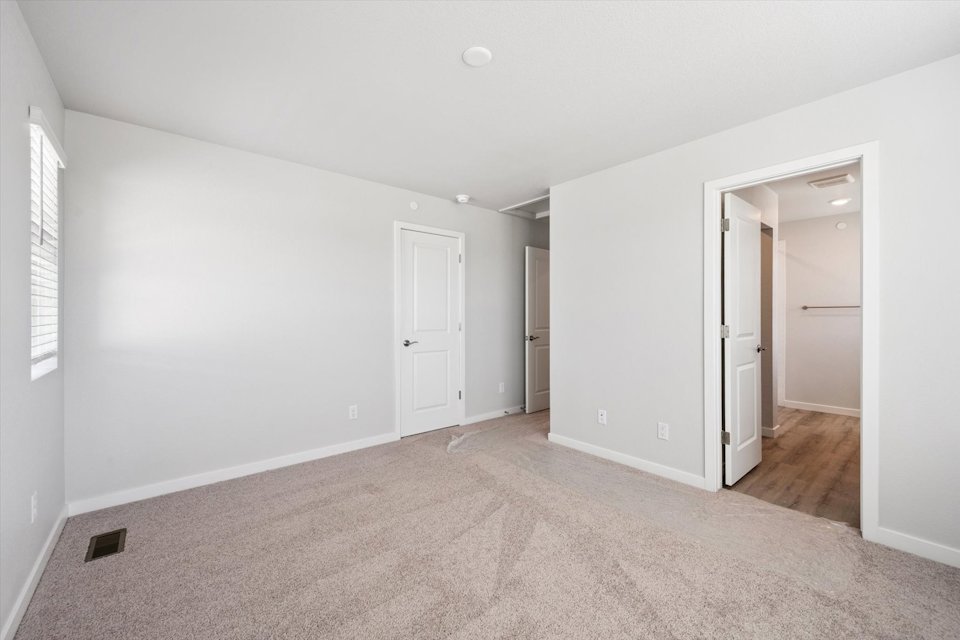 A hallway with white doors.