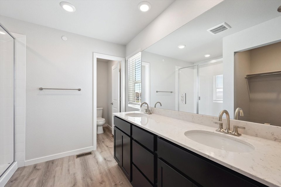 A bathroom with a large mirror.