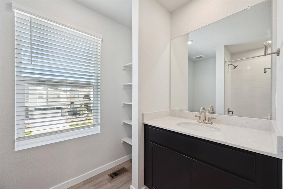 A bathroom with a large window.