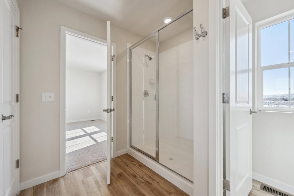 A room with a glass door and a wood floor.