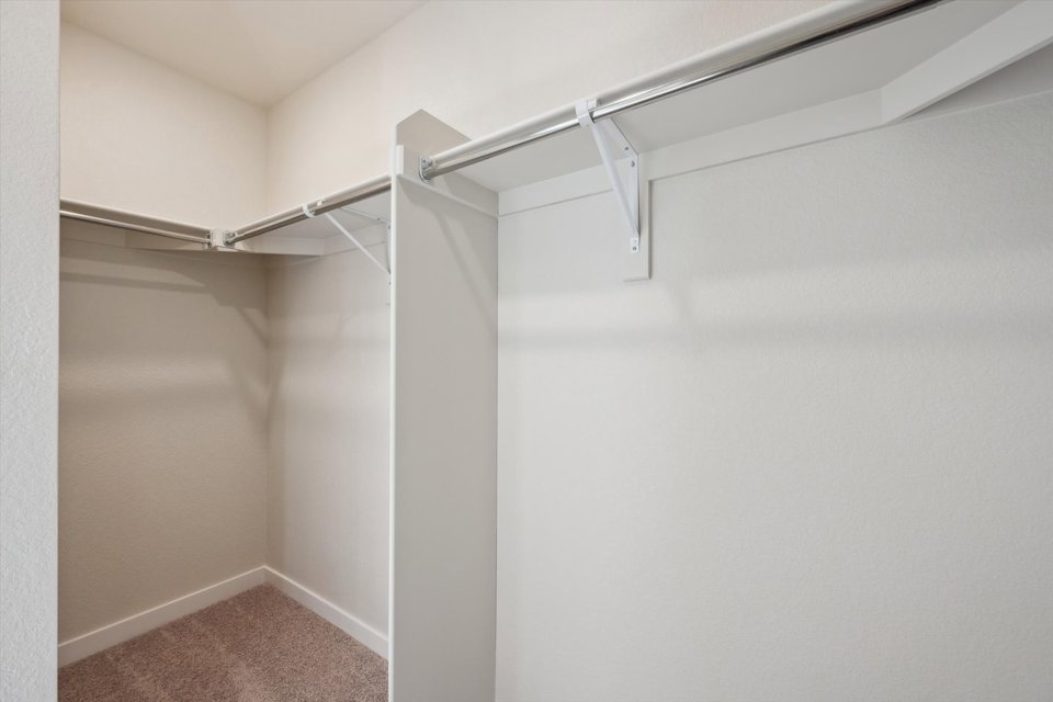 A white wall with a metal bar.