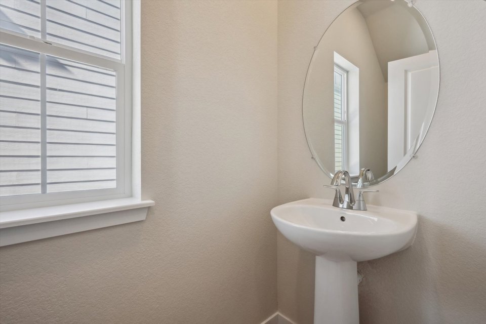 A bathroom with a mirror and sink.