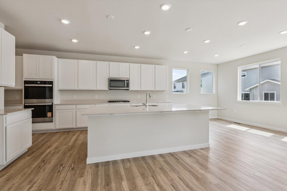 A kitchen with white cabinets.