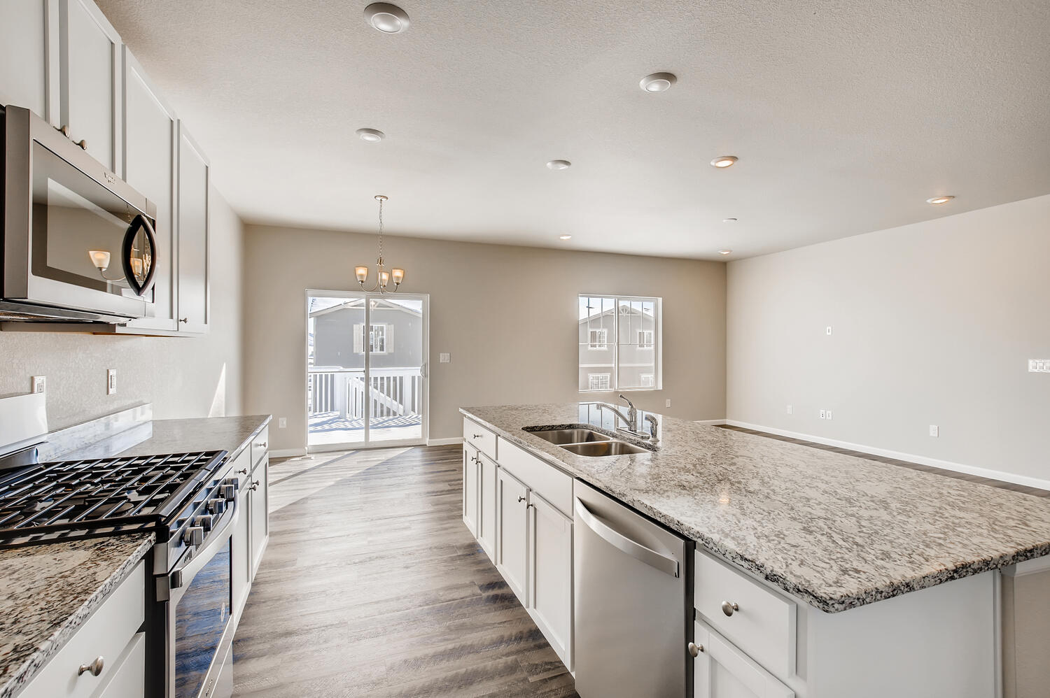 A kitchen with marble counters.