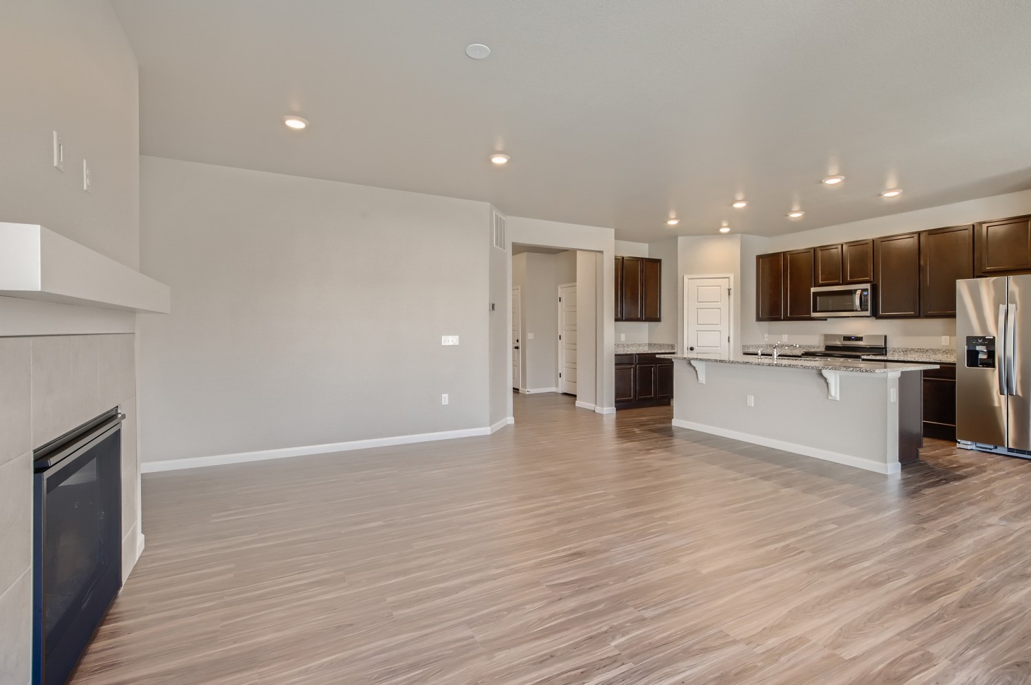 A large kitchen with wooden floors.