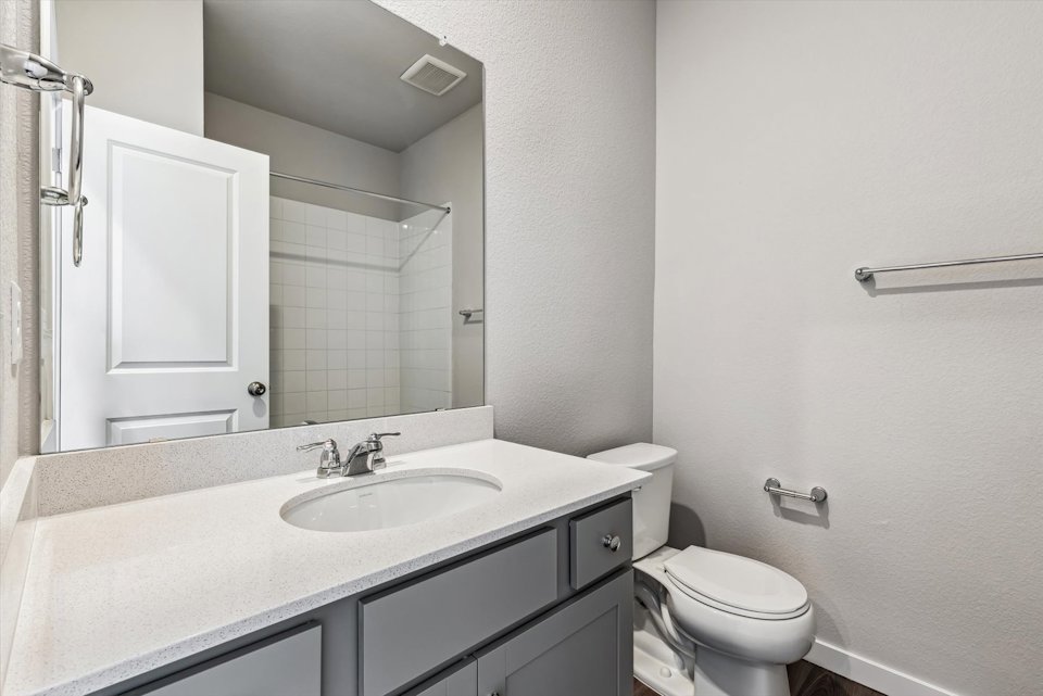 A bathroom with a sink and toilet.