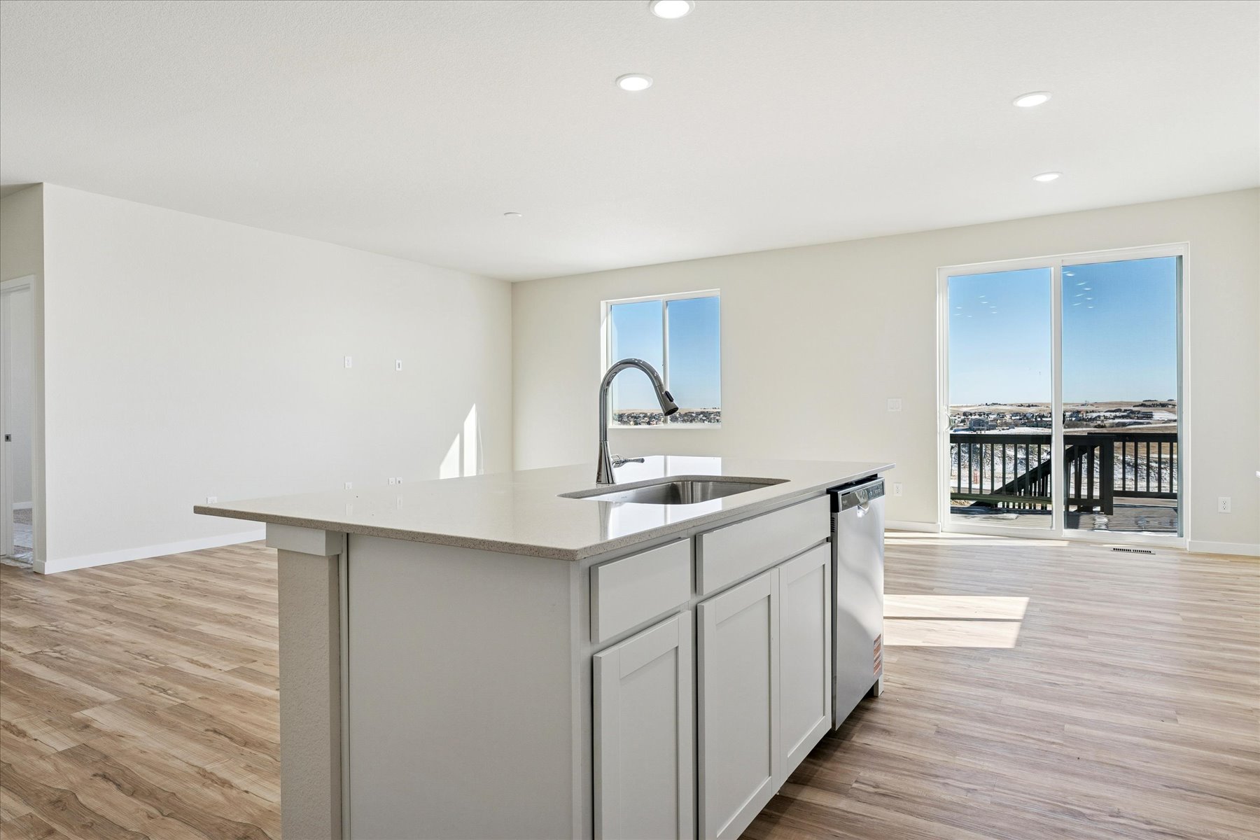 A kitchen with white cabinets.