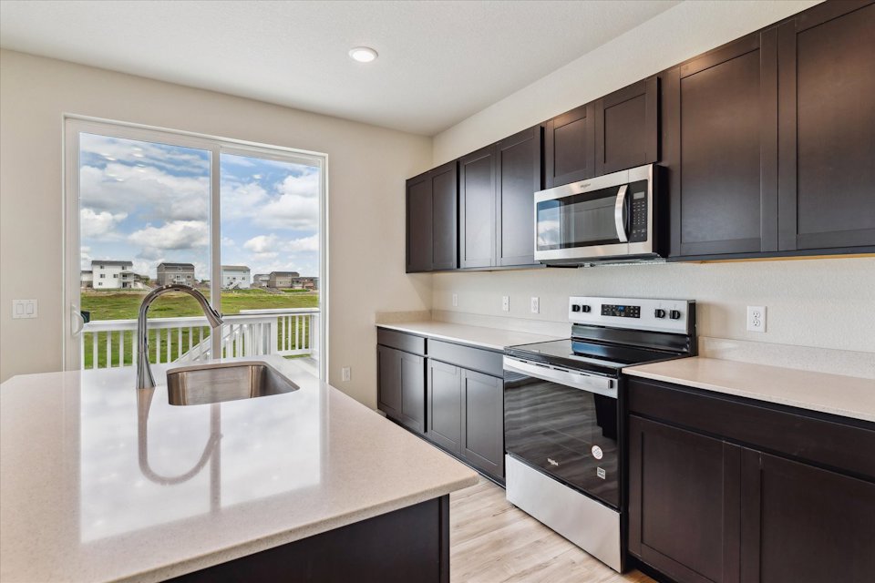 A kitchen with a large window.