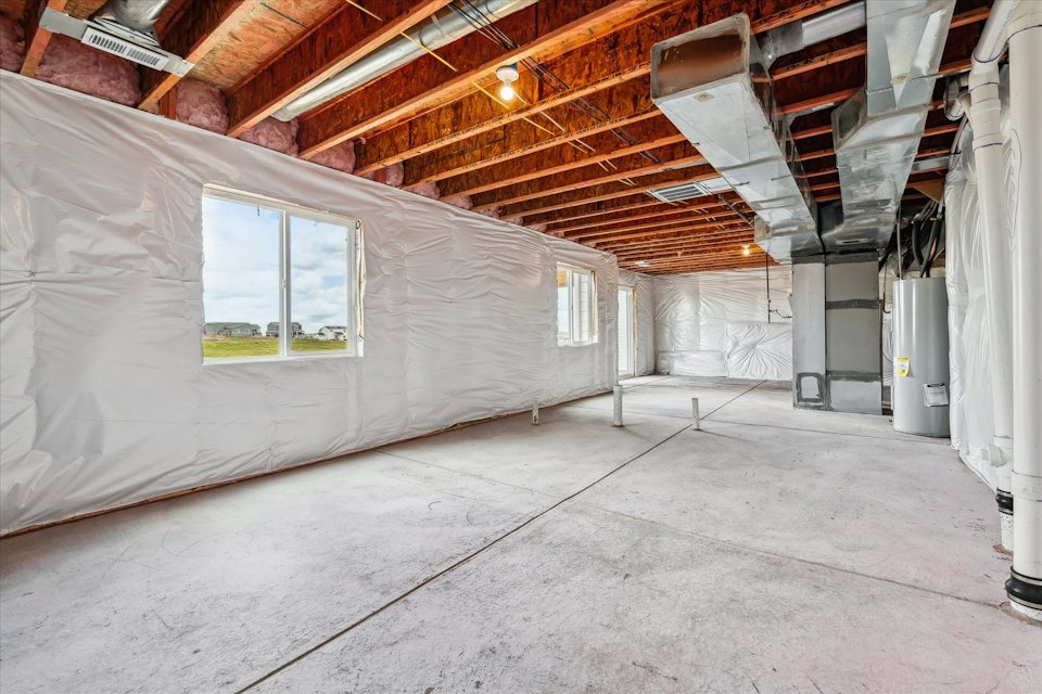 A room with a window and a wall with a light.