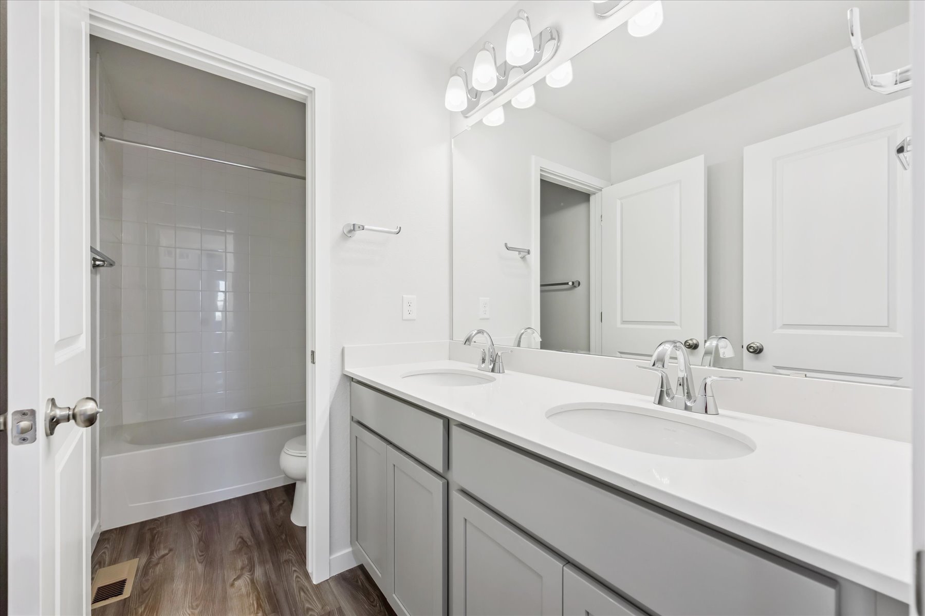 A bathroom with a sink and a shower unit.