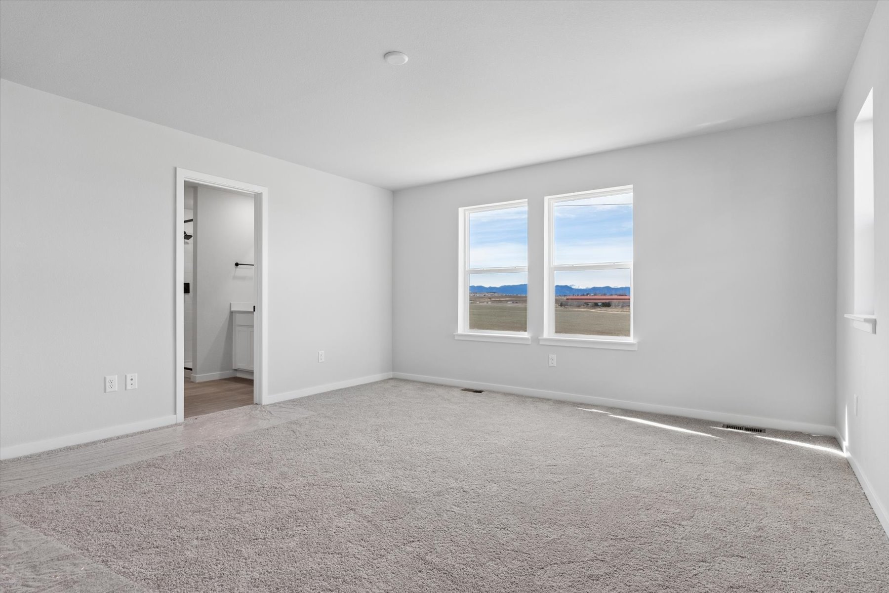 A room with a window and a door.