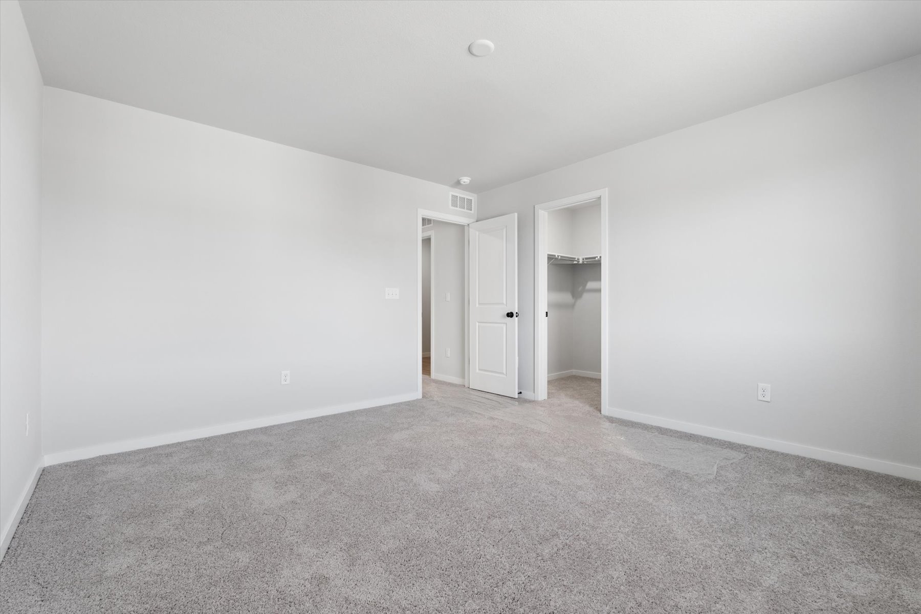 A hallway with white walls.