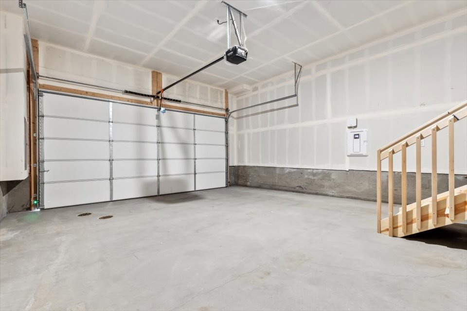 A room with white walls and a staircase.