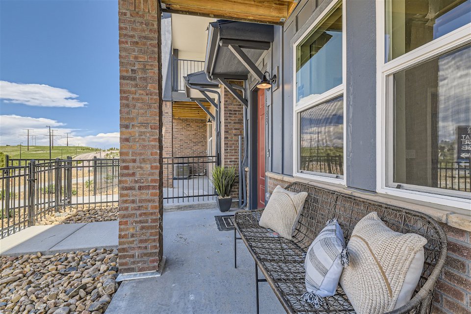 A patio with a couch and chairs.