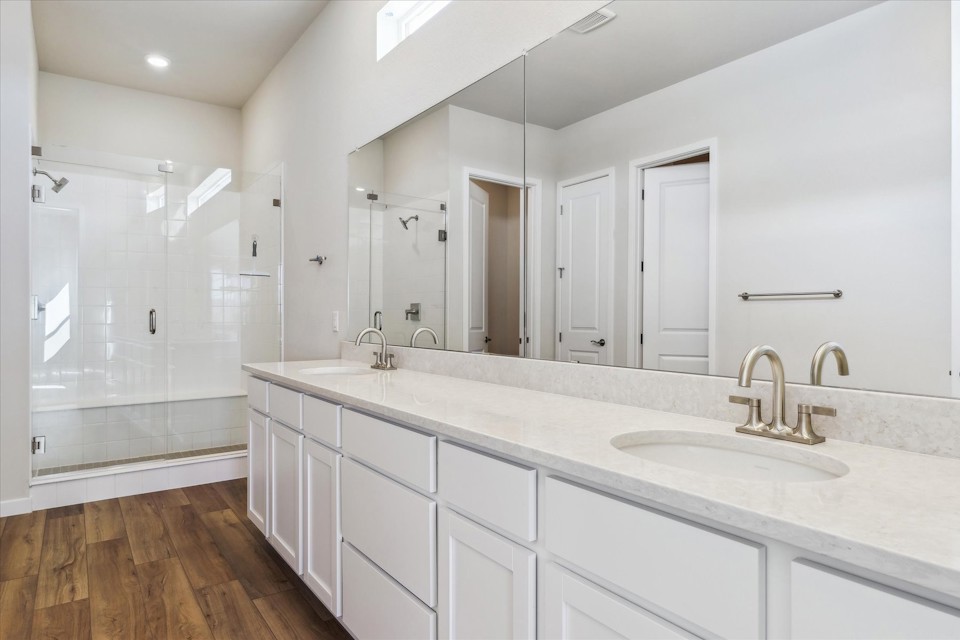 A bathroom with a large mirror.