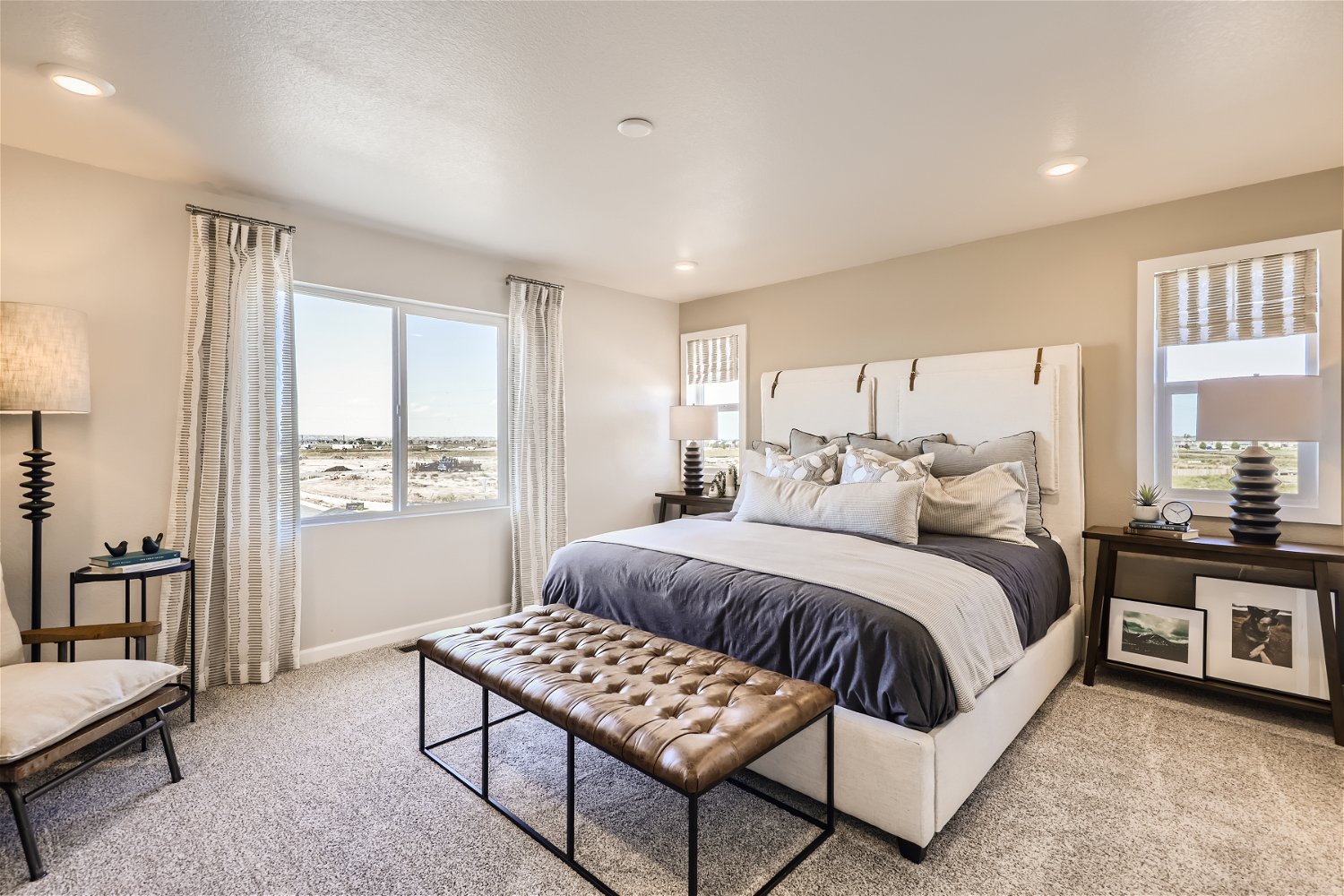 A bedroom with a large window.