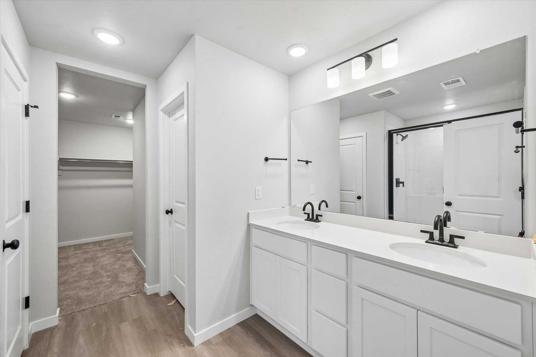 A bathroom with white cabinets.