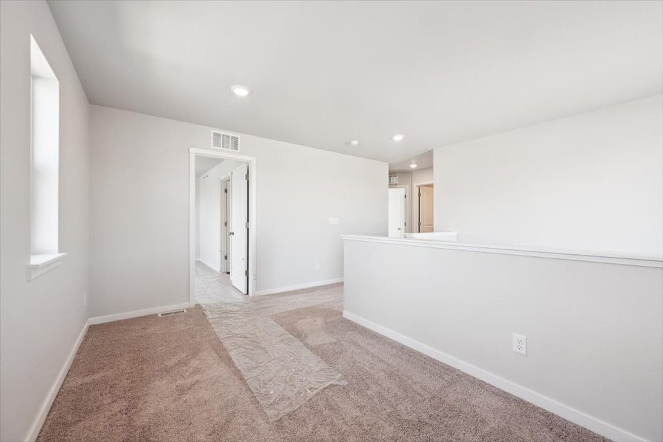 A hallway with a rug.