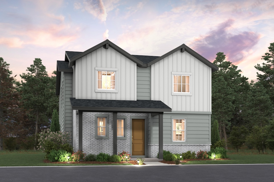 A grey house with trees in the background.