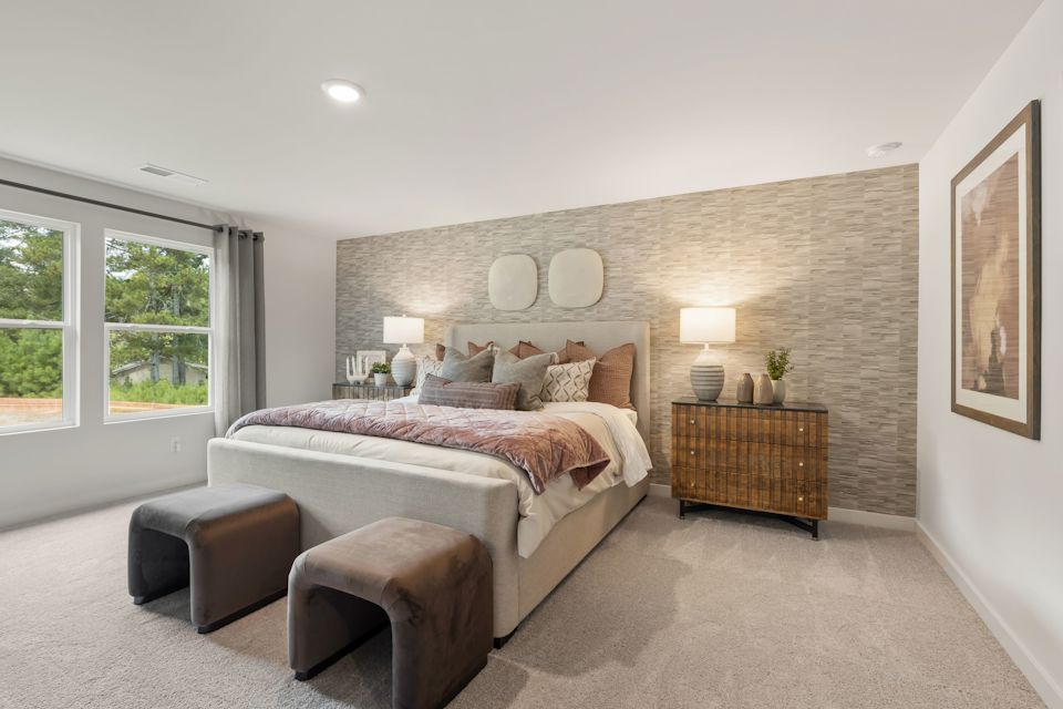 A bedroom with a bed and a couch.