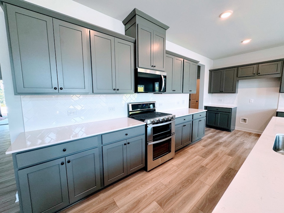 A kitchen with wooden cabinets.