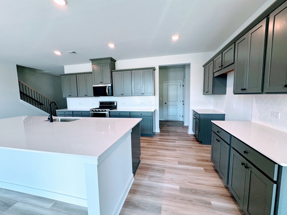 A kitchen with black cabinets.