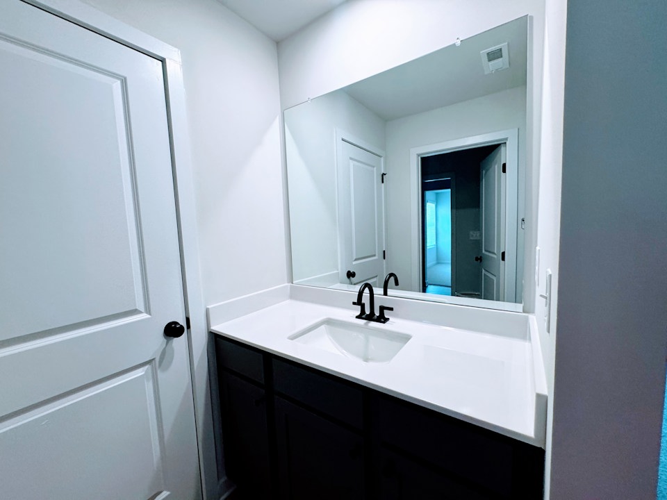 A bathroom with a sink and mirror.
