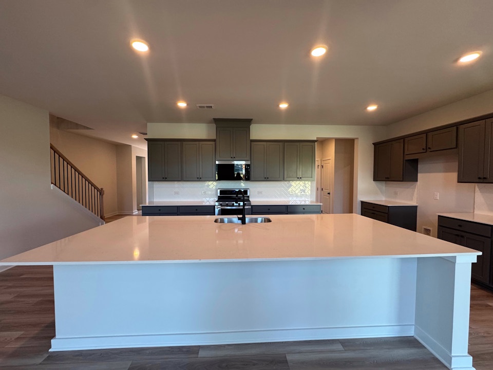 A kitchen with a bar and a bar.