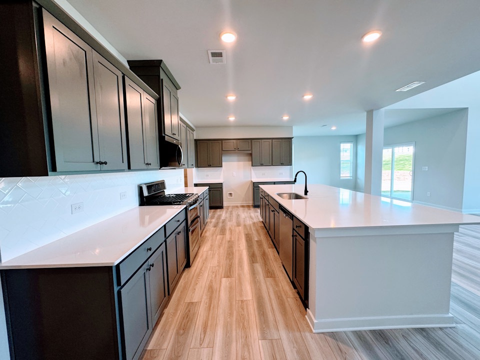 A kitchen with white cabinets.