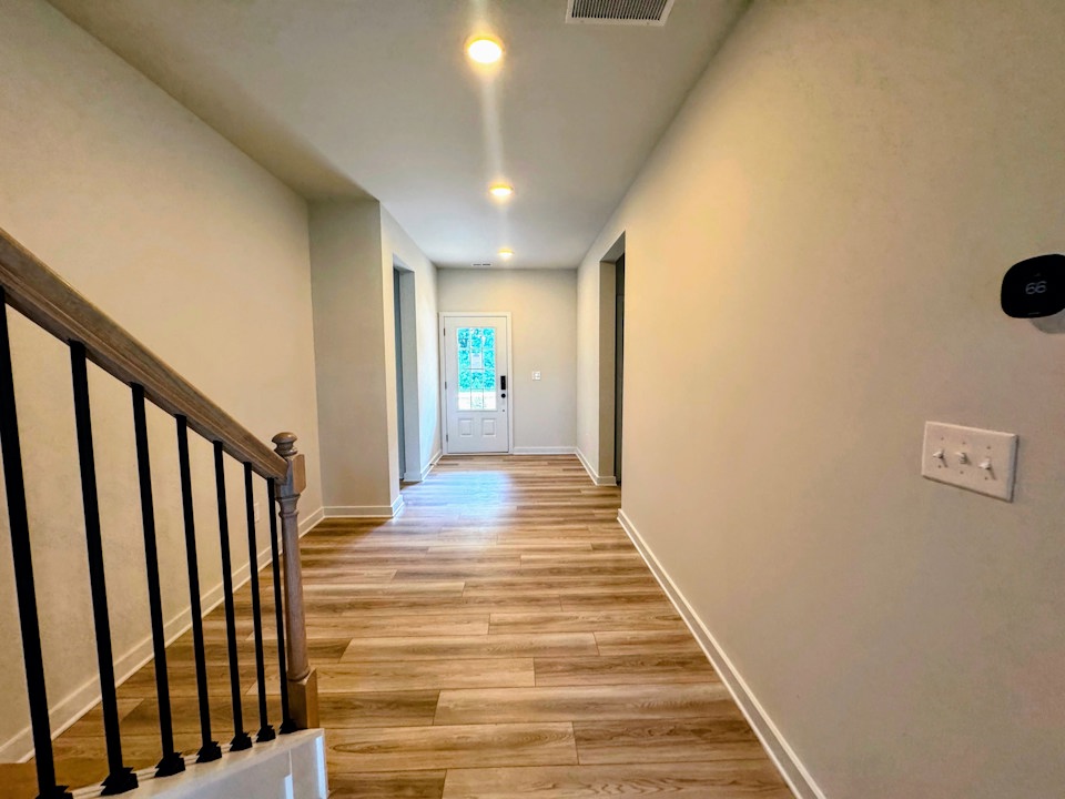 A hallway with wood floors.