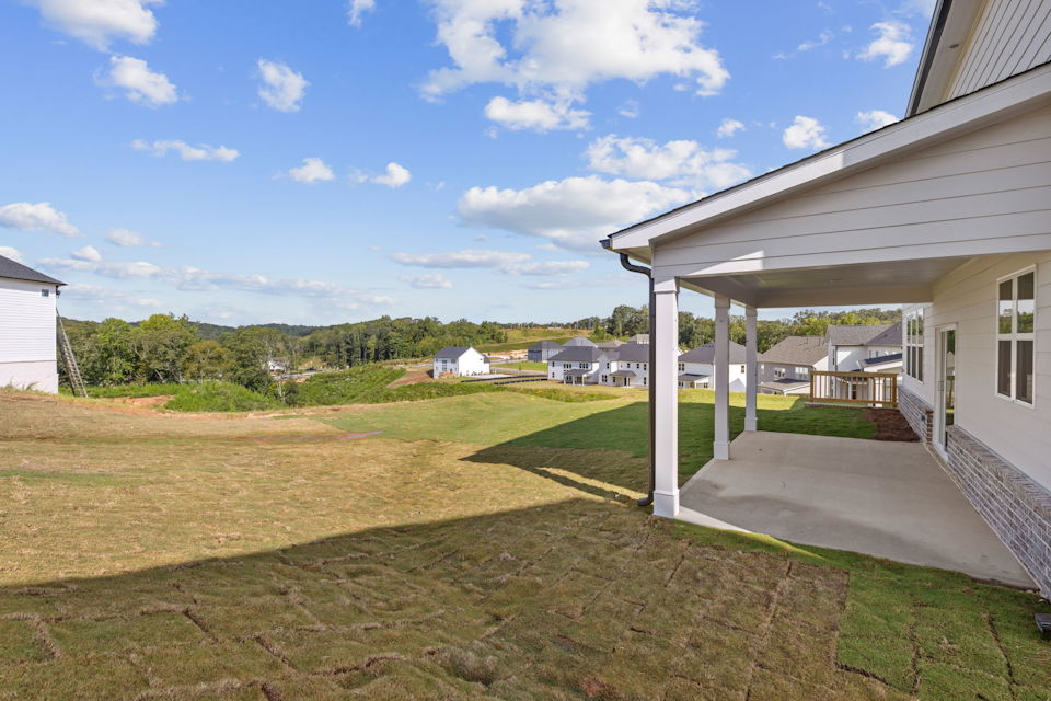 A backyard with a covered patio.