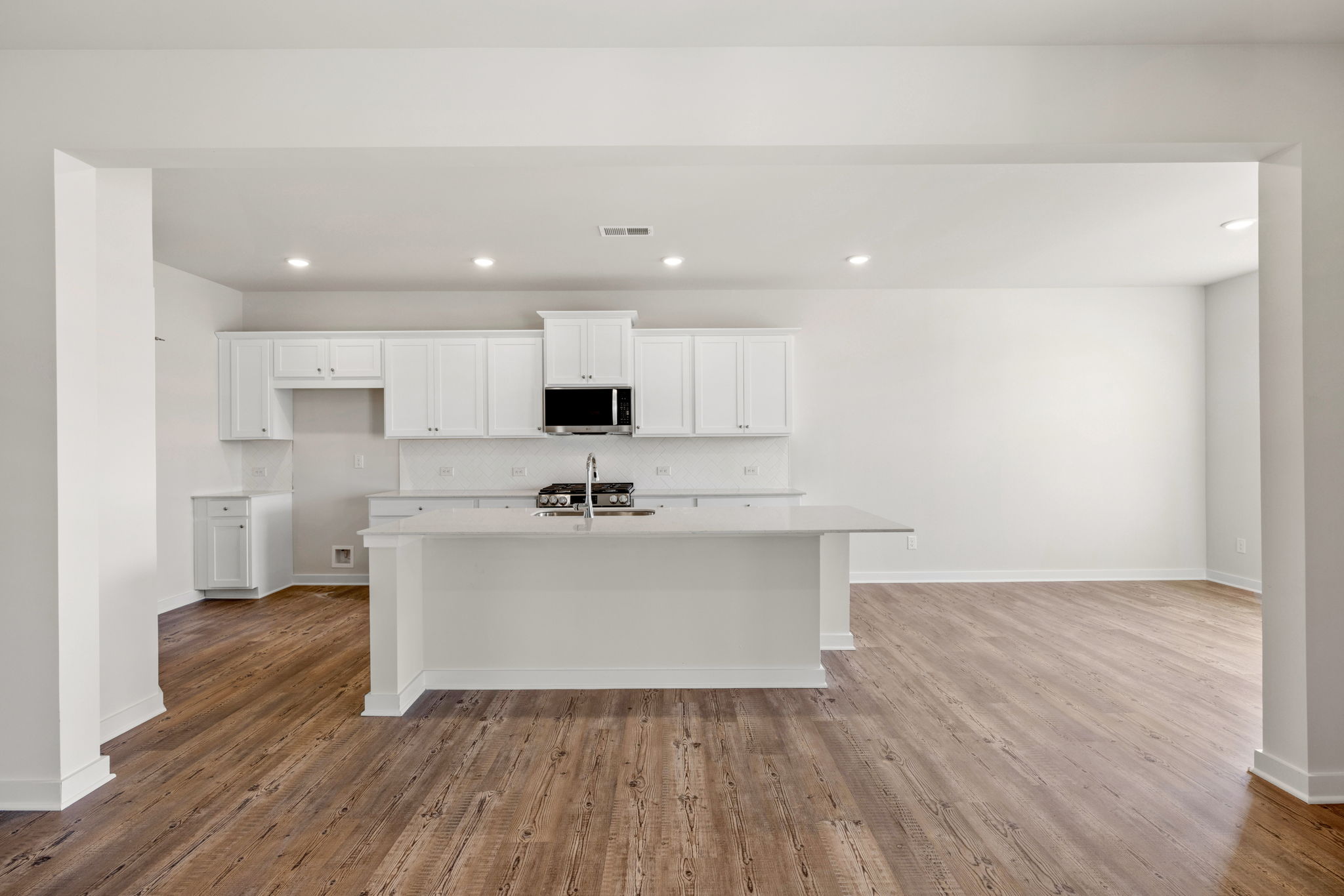 A kitchen with white cabinets.
