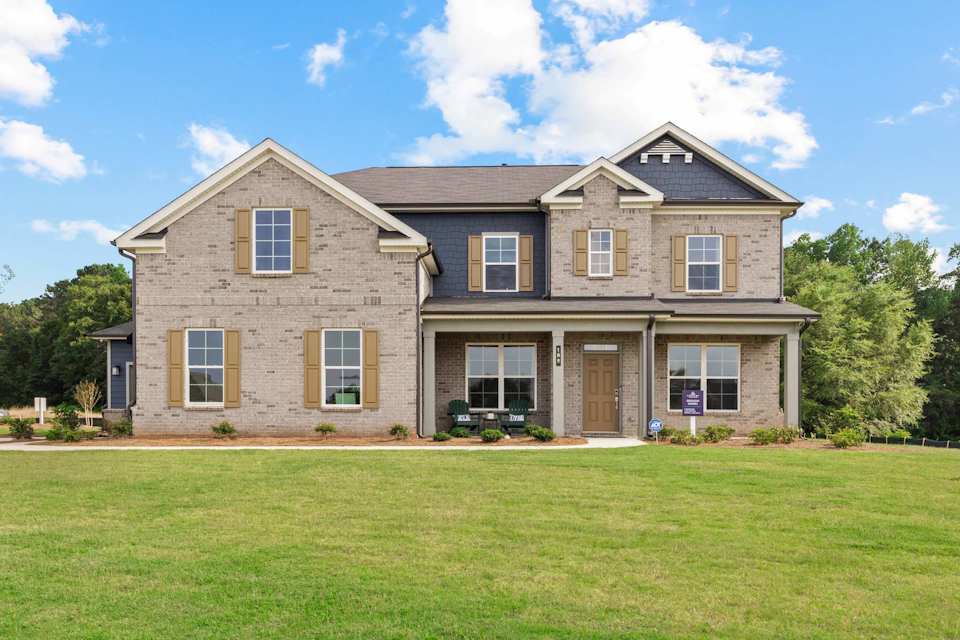 A large house with a lawn in front of it.