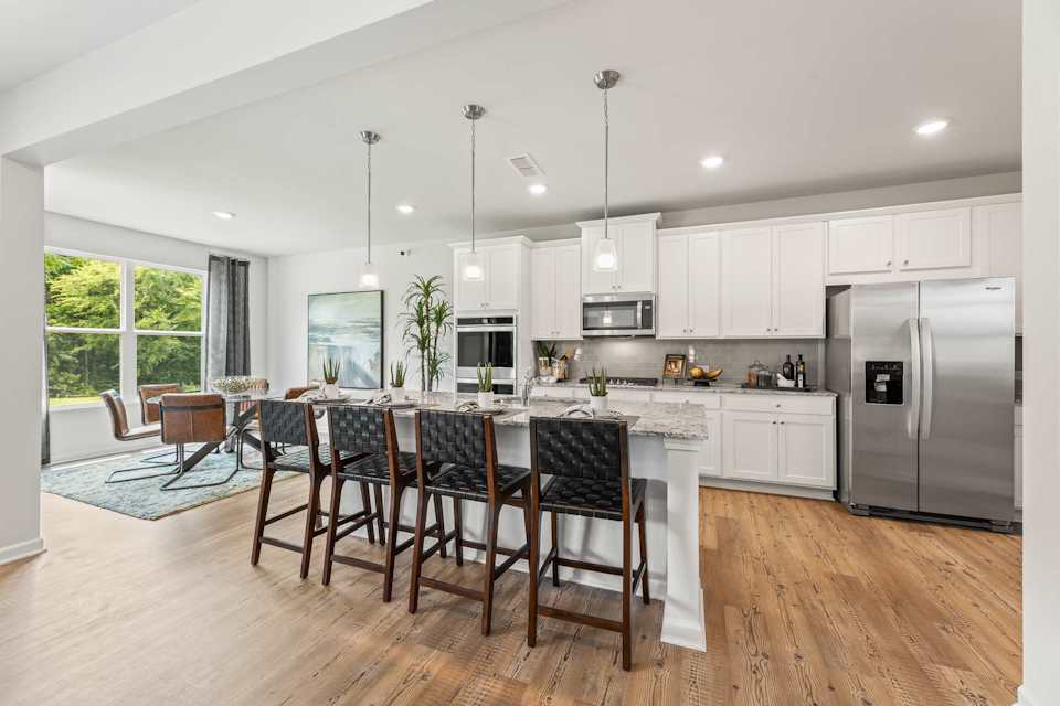 A kitchen with a wood floor.