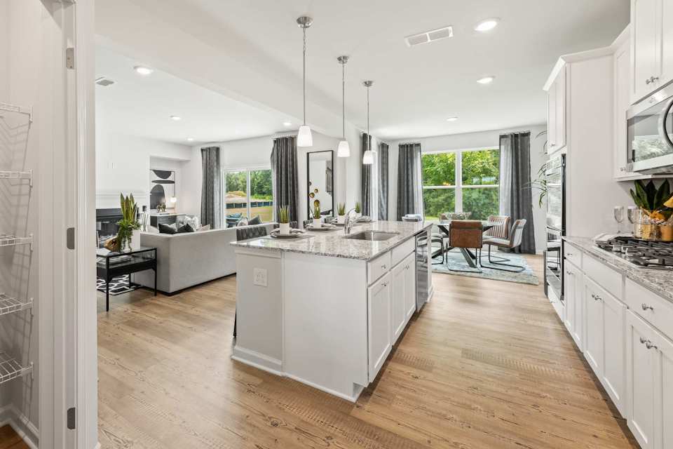 A kitchen with white cabinets.