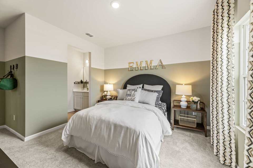 A bedroom with a bed and lamps.