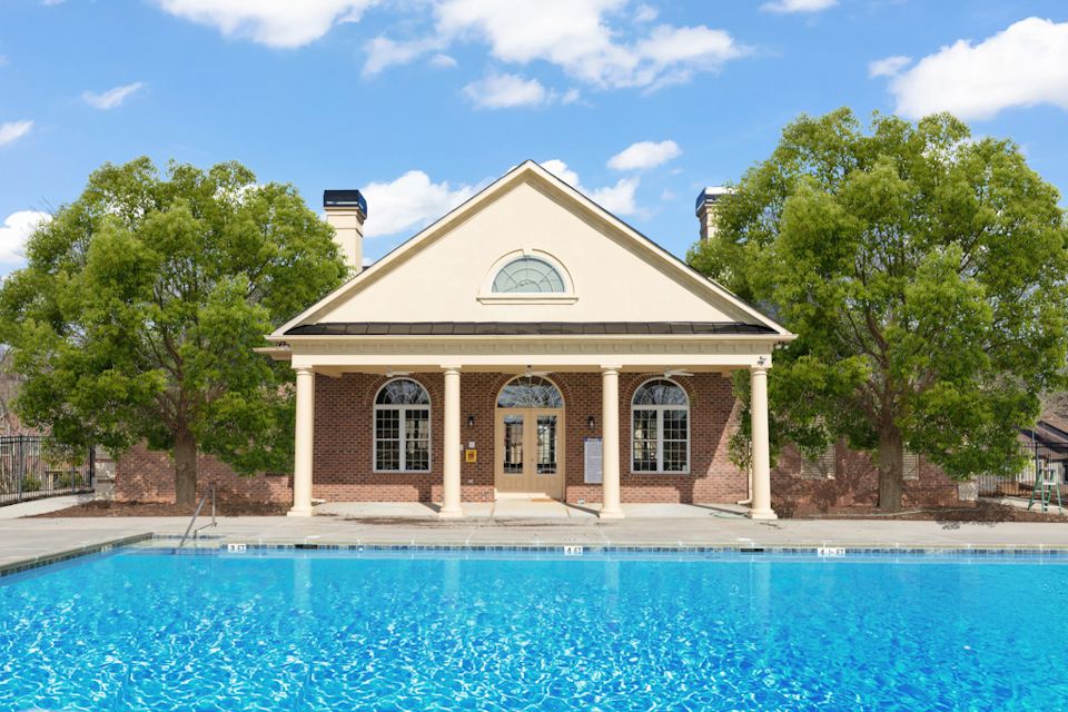 A house with a pool in front.