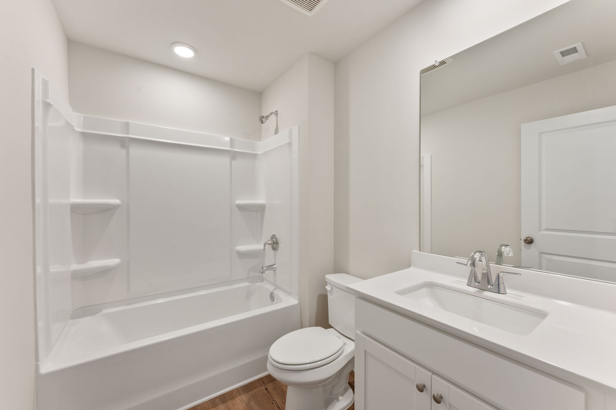 A bathroom with a tub toilet and sink.