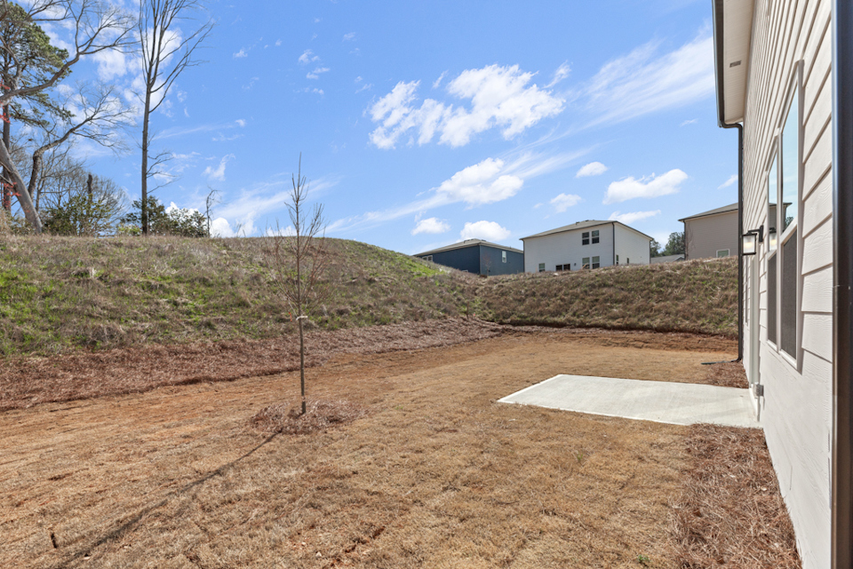 A dirt path leading to a building.