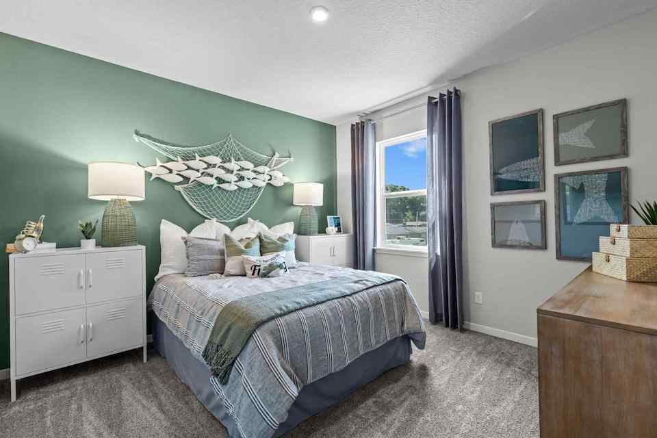 A bedroom with a bed and a dresser.