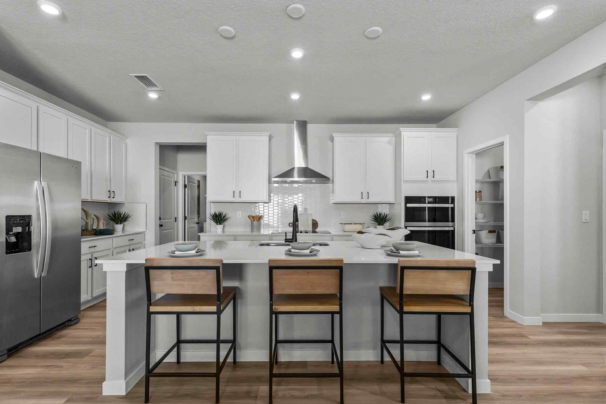 A kitchen with white cabinets.