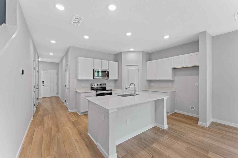 Davor Paired Home Kitchen with White Cabinets at The Landings at Pecan Park in Jacksonville