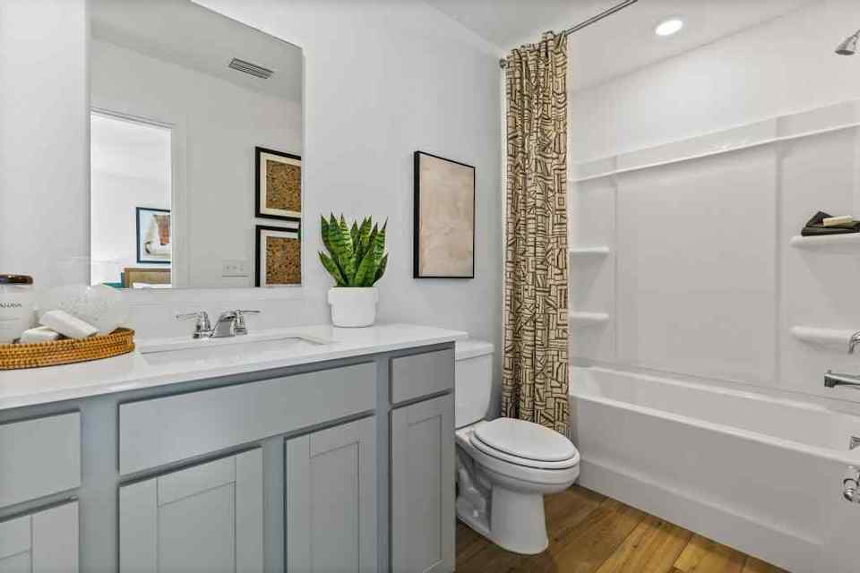 A bathroom with a tub sink and toilet.