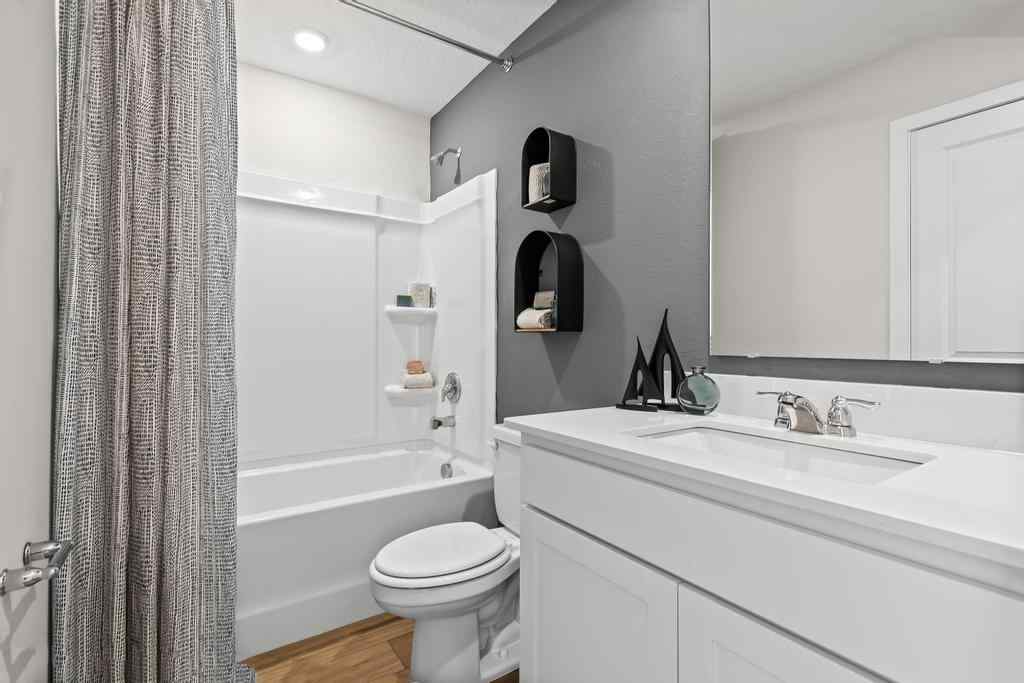 A bathroom with a tub sink and toilet.