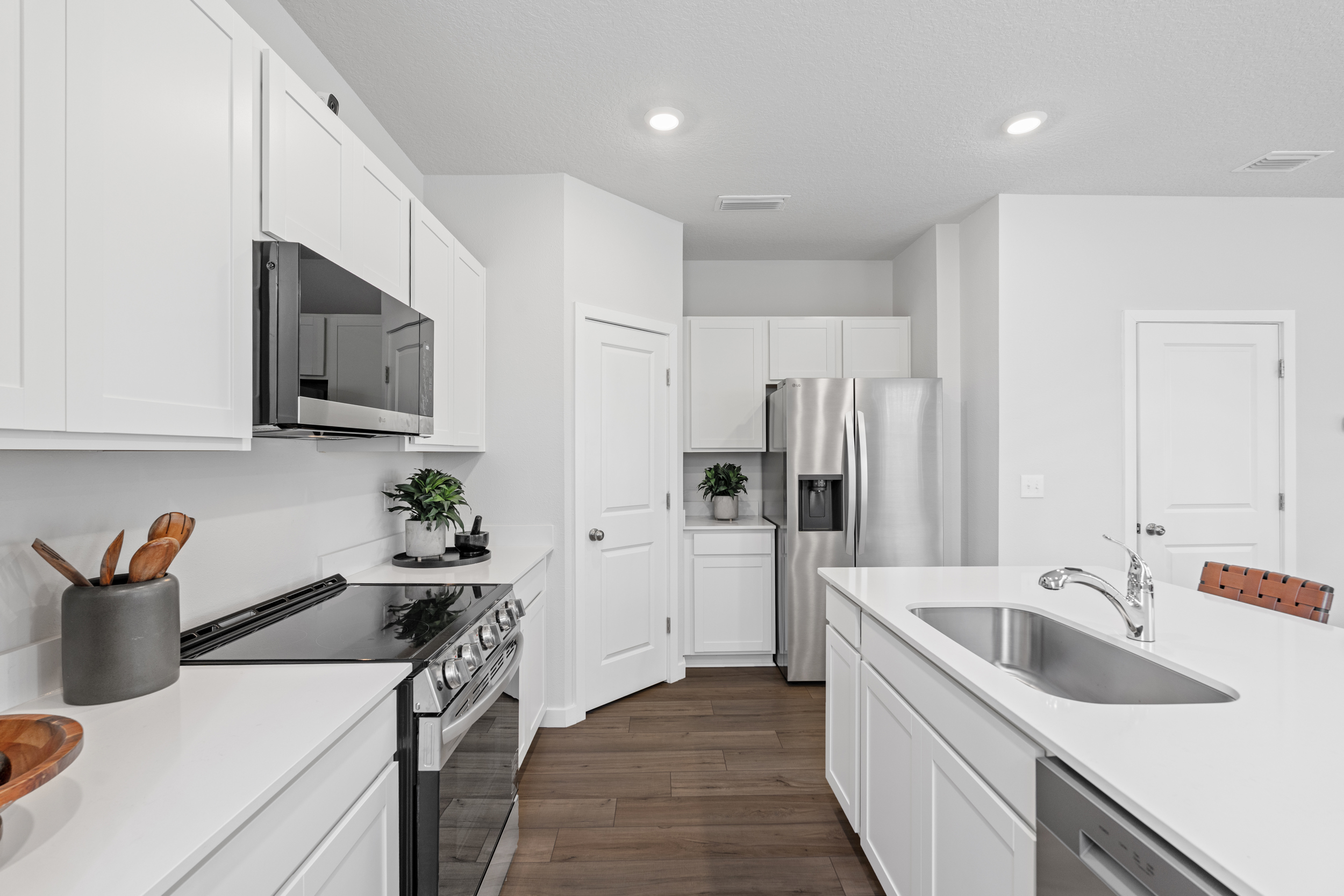 Crescent Plan Kitchen with LG Appliances at The Villas at Bishop Oaks